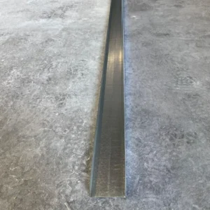 Long metal stud placed on a concrete floor, used in construction or framing projects.